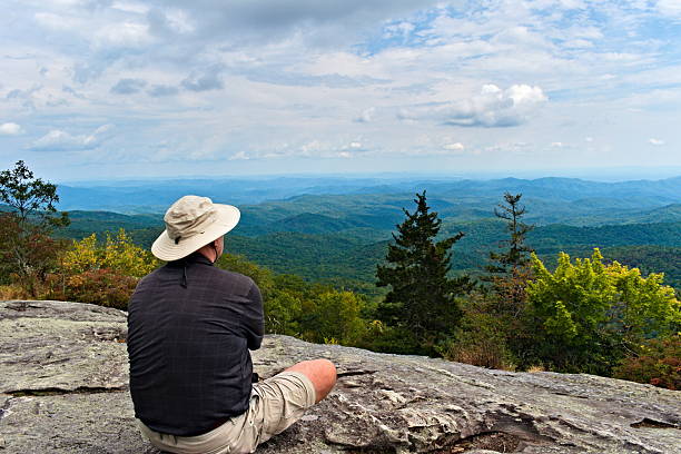 istock Hiker Sits and Gazes Out Over Valley 2239722815