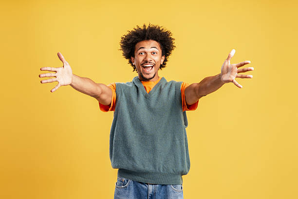 istock Happy young man with open arms welcoming joy 2239724142