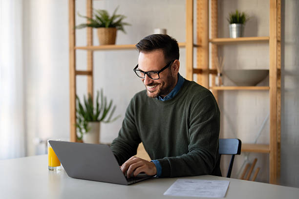 istock Success man typing on laptop, communicating online distantly working or studying on computer at home 2239725180
