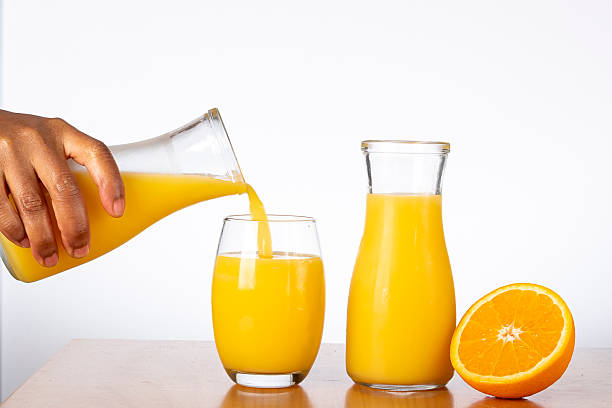 istock Serving fresh orange juice in a glass 2239726580