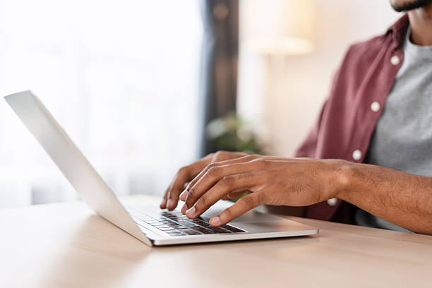 istock Man typing on laptop keyboard working remotely from home 2239727302