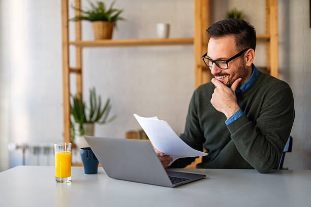 istock Business man accountant analyst holding documents, work at laptop computer doing online trade market 2239727305