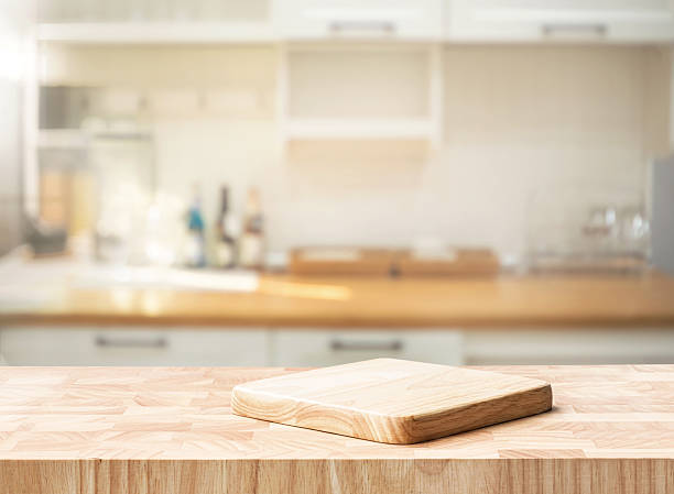istock Selective focus.End grain wood counter top with cutting board on blur cozy kitchen 2239728477