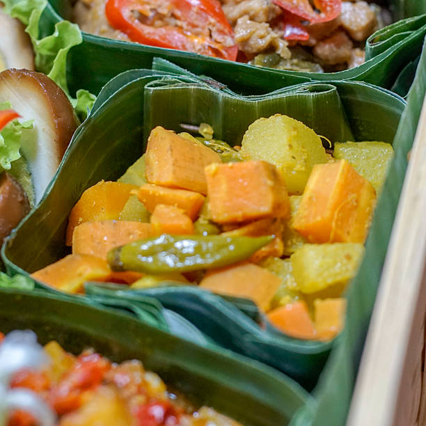 istock Authentic Indonesian acar kuning (yellow pickled vegetables) in banana leaf box 2239728764