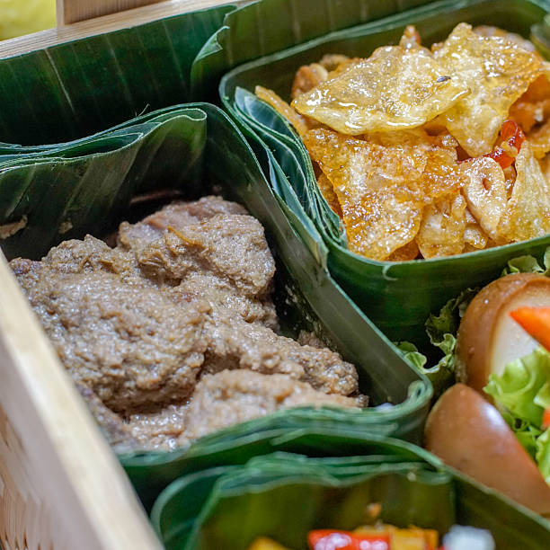 istock Indonesian rendang beef and spicy chips in banana leaf bamboo box 2239728838