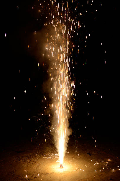 istock Diwali New Year celebrations with bright burning illuminated fireworks exploding high up against black night sky for posters, banners, greeting cards 2239738782