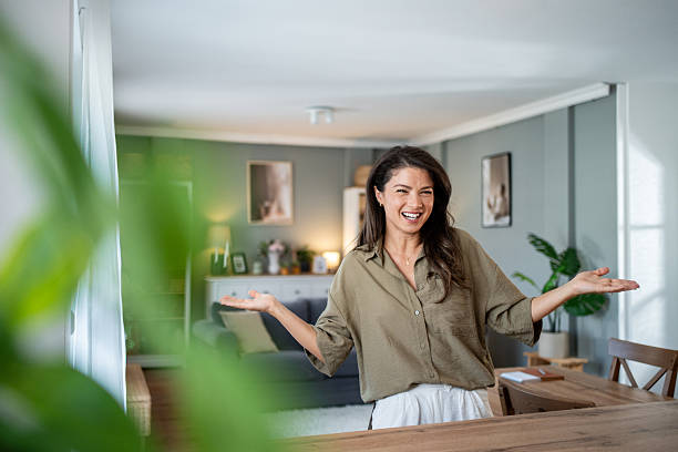 istock Woman inviting people into her modern home 2239738798