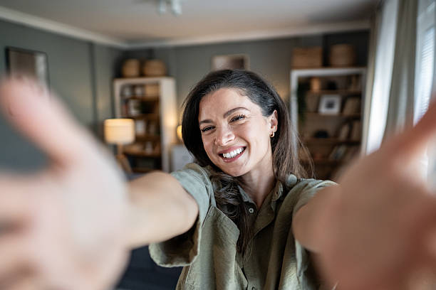 istock Happy woman taking selfie with outstretched hands 2239738839