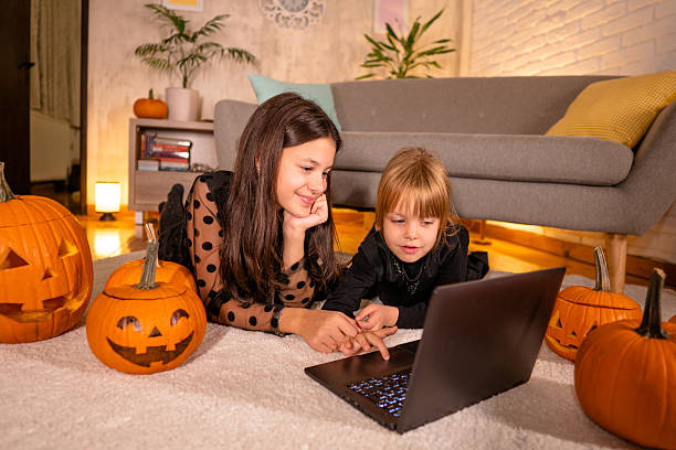 istock Girls using laptop for Halloween 2239739828
