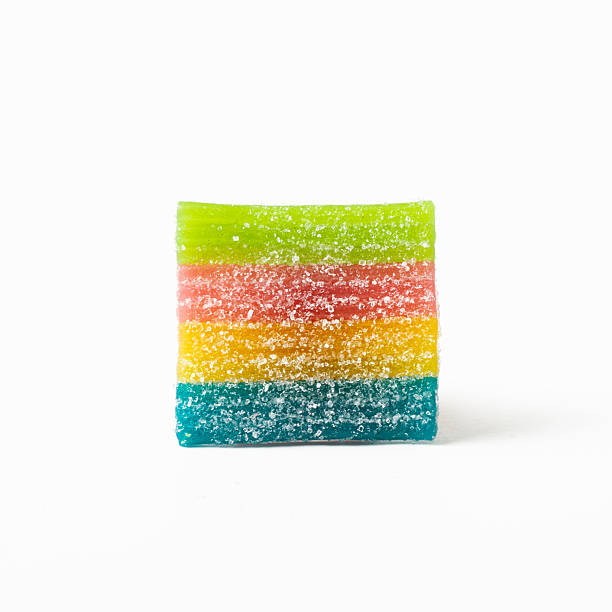 istock One square, rainbow-shaped gummy candy on a white background. Isolated. Macro 2239740581