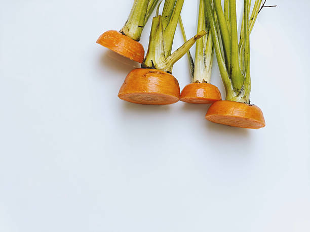 Carrot tops, on a white plate. Light background. Environmentally responsible behavior, ecological, recycling waste concept. Zero waste. sustainable consumption and conscious consumption. part of the series.