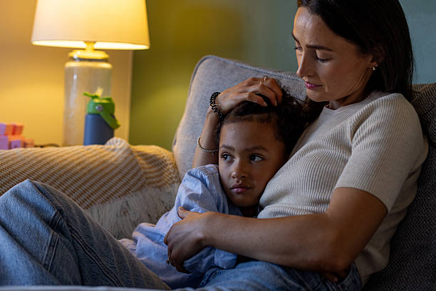 istock Mother and Son Embracing on the Sofa 2239742528