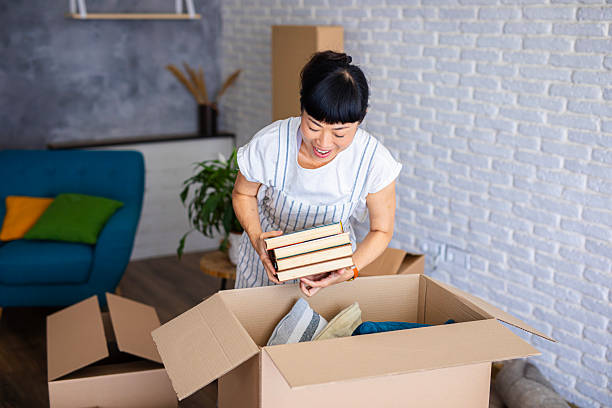 istock Japanese woman enjoying unpacking boxes during home move 2239744409