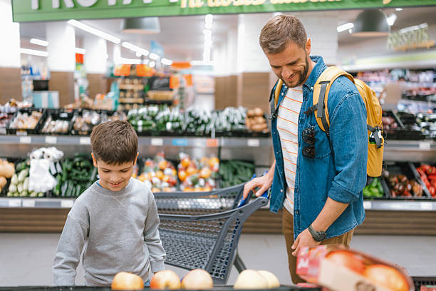 istock Father and son comparing fruits in grocery store 2239744691