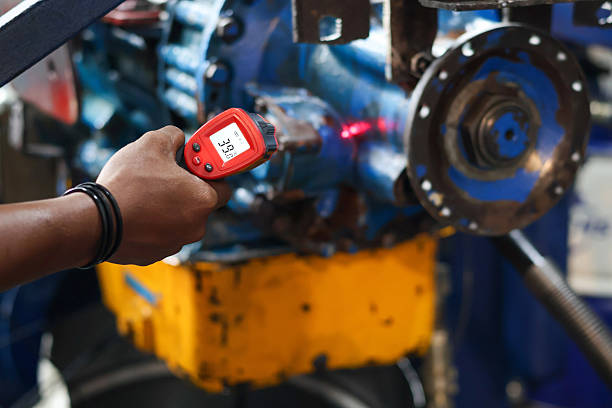 Close up technician hand holding a digital thermometer