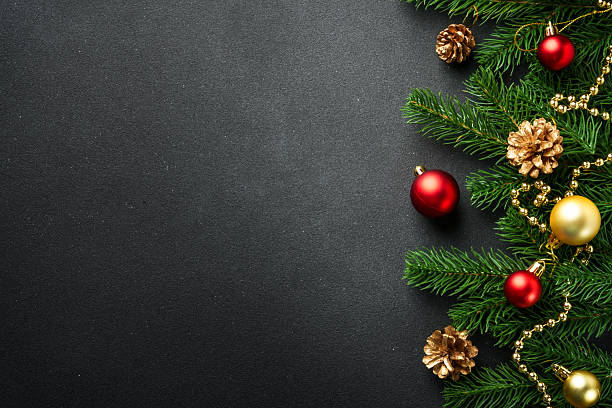 istock Christmas flat lay background with fir tree and holiday decorations on black. 2239746967