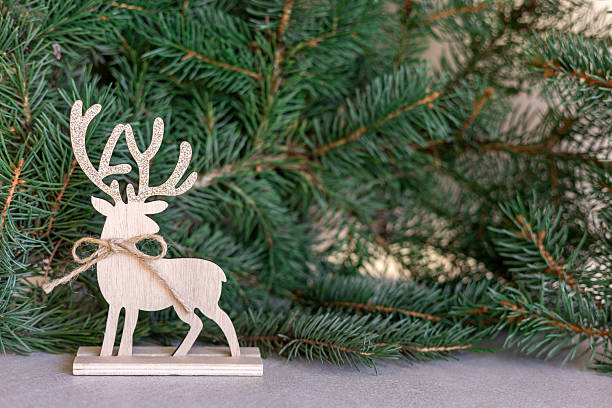 istock Wooden reindeer decoration with pine branches 2239747755