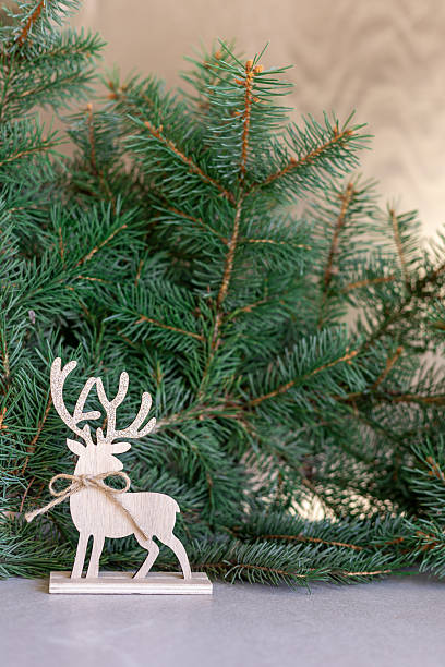istock Rustic wooden reindeer with festive pine branches 2239747767