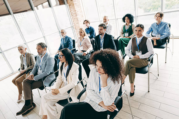 istock Professionals attending a corporate conference in a modern office setting with diverse participants and team collaboration 2239747851