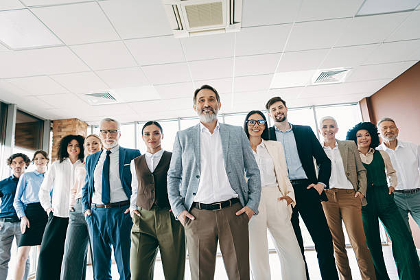 istock Diverse office team of professionals standing confidently in workplace, showcasing teamwork and collaboration among coworkers 2239747970