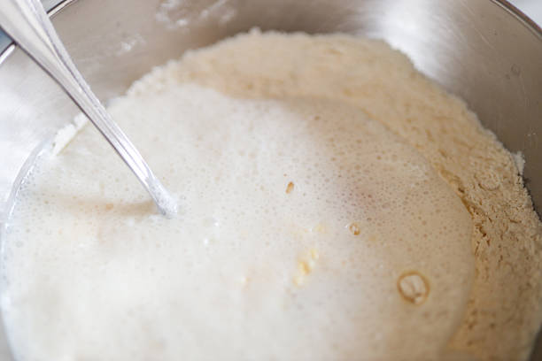 istock Mixing dough with flour and liquid in bowl 2239748958