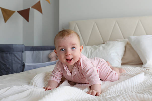 istock Six months old baby on the bed. 2239749352