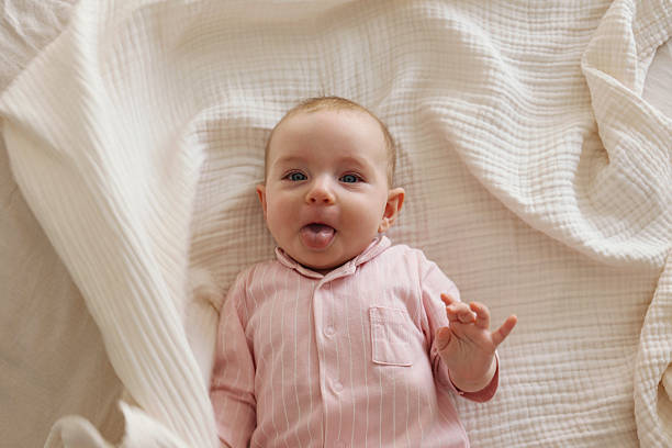 istock Six months old baby on the bed. 2239749361