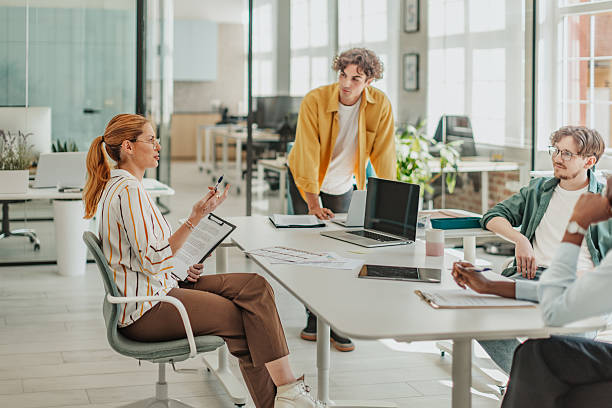 istock Young adults collaborate in a modern office space, discussing ideas and projects during a productive meeting 2239749625