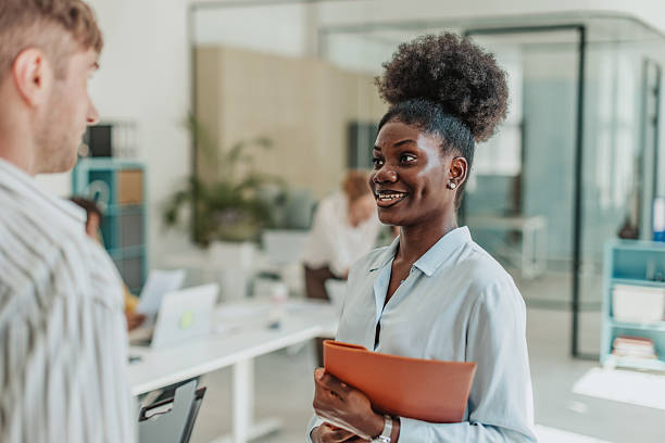 istock Young adults engage in teamwork and communication in a modern office setting during a productive business meeting 2239749923