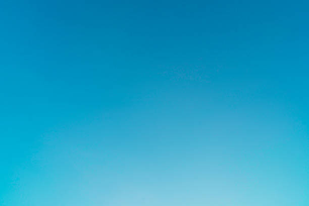A simple and minimalist view focusing on the vastness and gradient of a clear, bright blue sky. The color subtly lightens towards the lower part of the composition.