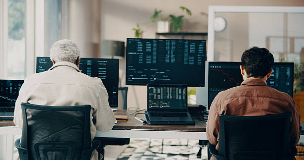 istock Men, computer screen and team with trading at office with stats for stock market, graphs and review. Business people, pc and monitor with charts, back and fintech with insight at investment agency 2239752590