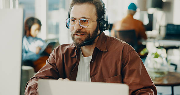 istock Headset, man and technical support agent in office with crm, communication or contact us. Happy, mic and male call center consultant with online consultation for customer service in workplace. 2239752624