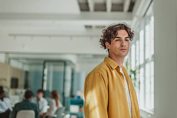 istock Young professional in a modern office space engages with colleagues during a collaborative work session 2239752727