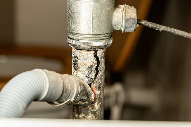 istock Broken drain pipe under bathroom sink, leaking water. Plumbing problem, home maintenance or emergency repair situation. Concept for household damage, insurance, plumbing services 2239753096