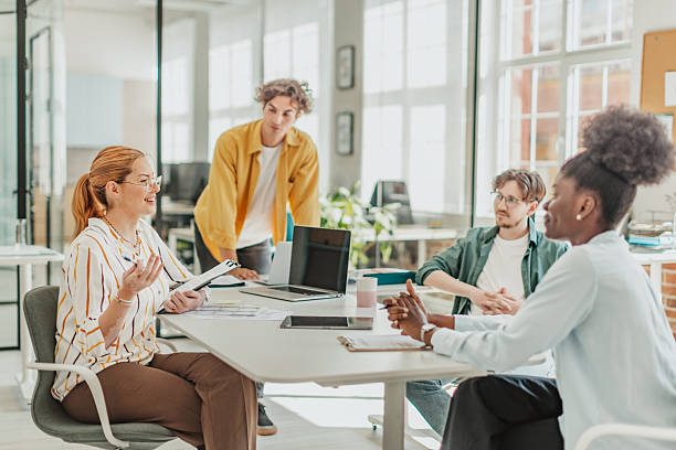 istock Young professionals collaborate in a bright, modern office to discuss ideas and enhance teamwork during a productive meeting 2239754345