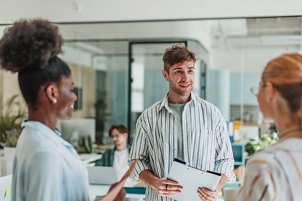 istock Young professionals collaborate in a modern office environment, sharing ideas and fostering teamwork 2239754714
