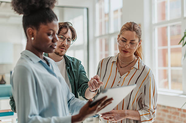istock Young professionals collaborate in a modern office setting to enhance team communication and achieve business goals 2239754968