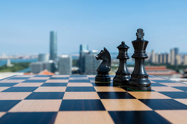 istock Chess king, queen and knight on city background 2239755375