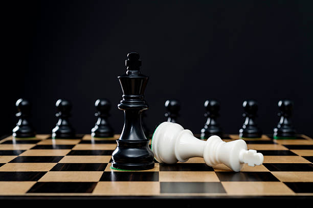 istock Black king standing and white king falling 2239755386