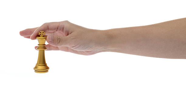 istock Human hand holding chess king on white background 2239755446