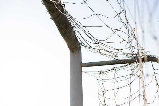 Low angle view of soccer goal net against sky