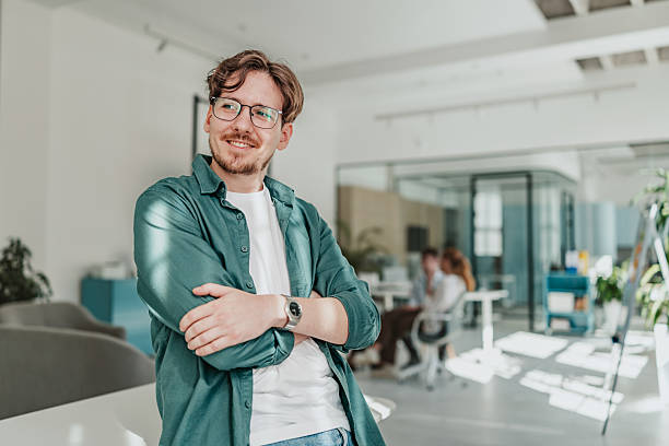 istock Young professionals collaborating in a modern office while enjoying their work and fostering connections with colleagues 2239756288