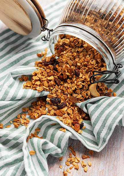 istock Granola pouring from jar on striped cloth 2239756297