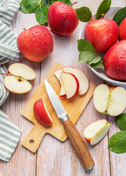 istock Fresh aed apples slicing on wooden cutting board 2239756338
