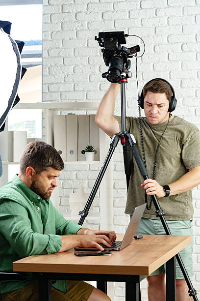 istock Filming a content creation session in a modern studio with two focused individuals 2239756722