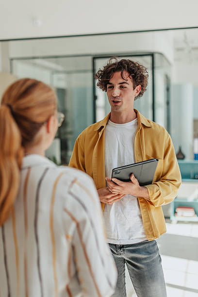istock Young professionals engage in communication and collaboration in a modern office environment 2239757006