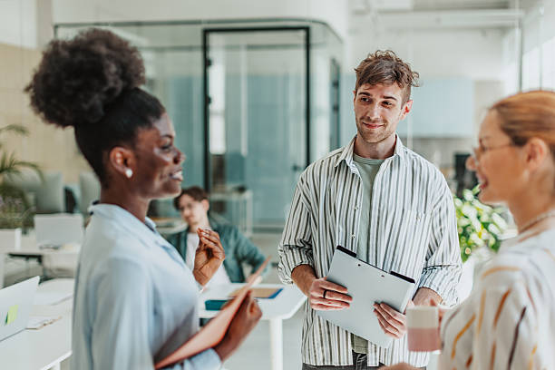 istock Young professionals engaging in collaboration and communication in a modern office setting 2239759447