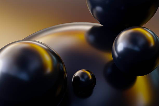 A striking macro image featuring glossy black spheres with warm yellow reflections, creating an abstract, futuristic feel. The close-up composition emphasizes depth, texture, and smooth, curving forms.