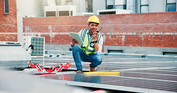 istock Tablet, solar panel worker and radio on rooftop for PV installation, troubleshooting or maintenance. Talking, photovoltaic technician and tech with feedback for renewable energy and site assessment 2239763913