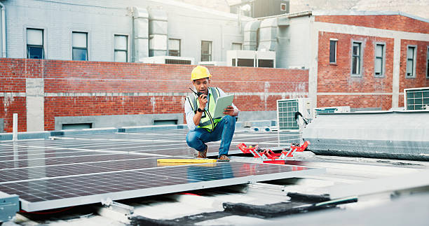 istock Tablet, solar panel worker and radio outdoor for PV installation, troubleshooting or maintenance. App, photovoltaic technician or tech with feedback on rooftop for renewable energy or site inspection 2239763923